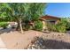 Single-story home with desert landscaping and a healthy tree at 43121 W Sunland Dr, Maricopa, AZ 85138