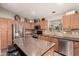 Modern kitchen with stainless steel appliances and a granite island at 43121 W Sunland Dr, Maricopa, AZ 85138
