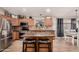 Eat in kitchen featuring stainless steel appliances and a breakfast bar with seating at 43121 W Sunland Dr, Maricopa, AZ 85138