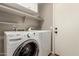 The laundry room features a white washer and dryer, storage shelving, and a utility sink at 43121 W Sunland Dr, Maricopa, AZ 85138