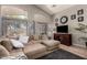 Spacious living room with vaulted ceilings, large windows, and comfortable sectional seating at 43121 W Sunland Dr, Maricopa, AZ 85138