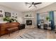 Cozy living room featuring a stone fireplace and a piano at 43121 W Sunland Dr, Maricopa, AZ 85138