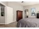 Well-lit main bedroom with an adjoining bathroom entrance at 43121 W Sunland Dr, Maricopa, AZ 85138