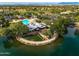 Breathtaking aerial view featuring the community clubhouse, pool, and surrounding landscaped grounds by a lake at 4322 S Ranger Trl, Gilbert, AZ 85297