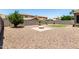 A beautiful desert landscaped backyard with a paved fire pit area and privacy wall at 4322 S Ranger Trl, Gilbert, AZ 85297