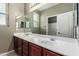 Bathroom showcasing double vanity with sink and mirror, and an entrance to the shower and toilet at 4322 S Ranger Trl, Gilbert, AZ 85297