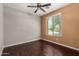 Bedroom with a ceiling fan, wood floors, and a window with a view of the neighborhood at 4322 S Ranger Trl, Gilbert, AZ 85297