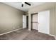 Bedroom with neutral paint and closet and bathroom doors, with carpeted floors and ceiling fan at 4322 S Ranger Trl, Gilbert, AZ 85297