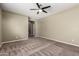 Spacious bedroom showcasing dark carpet and neutral walls, creating a serene atmosphere at 4322 S Ranger Trl, Gilbert, AZ 85297