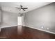 Spacious bedroom featuring wood floors, a modern ceiling fan, and neutral paint colors at 4322 S Ranger Trl, Gilbert, AZ 85297