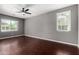 Large, bright bedroom boasting hardwood floors, a ceiling fan, and natural light at 4322 S Ranger Trl, Gilbert, AZ 85297