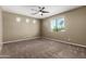 This airy bedroom features a ceiling fan, neutral walls, carpet and natural light at 4322 S Ranger Trl, Gilbert, AZ 85297