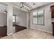 Open dining area with tile flooring, modern light fixture, and a view into the living room at 4322 S Ranger Trl, Gilbert, AZ 85297