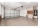 Spacious garage with epoxy floors, white cabinets, and an automatic door at 4322 S Ranger Trl, Gilbert, AZ 85297