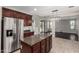 Kitchen island with granite countertops, stainless steel refrigerator, and tile floors in a well-designed layout at 4322 S Ranger Trl, Gilbert, AZ 85297