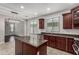 Eat-in kitchen features dark wood cabinets, granite countertops, tile flooring, and stainless steel appliances at 4322 S Ranger Trl, Gilbert, AZ 85297