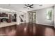Open-concept living room with hardwood floors leading to the kitchen and a staircase in the background at 4322 S Ranger Trl, Gilbert, AZ 85297