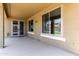 Covered patio with an access door and large windows overlooking the backyard at 4322 S Ranger Trl, Gilbert, AZ 85297
