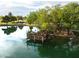 Scenic pond view featuring a wooden pier and lush greenery, creating a serene and inviting atmosphere at 4322 S Ranger Trl, Gilbert, AZ 85297