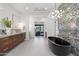 Modern bathroom with double vanity, soaking tub, and black and white decorative walls at 4763 N 53Rd St, Phoenix, AZ 85018
