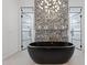 Chic bathroom featuring a soaking tub, decorative wall, and glass-enclosed shower stalls at 4763 N 53Rd St, Phoenix, AZ 85018