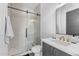 Modern bathroom with glass-enclosed shower, gray vanity, and stylish fixtures at 4763 N 53Rd St, Phoenix, AZ 85018