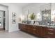 A luxurious bathroom featuring double vanity, granite countertop, and modern fixtures at 4763 N 53Rd St, Phoenix, AZ 85018