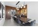 An open concept dining room showcases modern lighting, a built-in bar, and access to other living spaces at 4763 N 53Rd St, Phoenix, AZ 85018