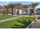 Charming desert home with lush green lawn, palm trees, and a landscaped walkway at 4763 N 53Rd St, Phoenix, AZ 85018
