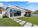 Modern exterior showcasing clean lines, expansive windows, lush lawn, and mountain views, blending seamlessly with nature at 4763 N 53Rd St, Phoenix, AZ 85018