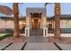A modern home's entryway featuring a gated entrance, palm trees with decorative lights, and a warm ambiance at 4763 N 53Rd St, Phoenix, AZ 85018