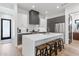 Chic kitchen with an island, seating, sleek white countertops, and stainless steel appliances for the modern home at 4763 N 53Rd St, Phoenix, AZ 85018