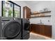 Bright laundry room with modern appliances, ample storage, and a convenient sink area, making chores a breeze at 4763 N 53Rd St, Phoenix, AZ 85018