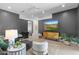 Modern living room with statement walls, comfortable seating, and a large screen television at 4763 N 53Rd St, Phoenix, AZ 85018