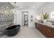 The primary bathroom boasts a freestanding tub, dual vanity, modern lighting, and decorative tile at 4763 N 53Rd St, Phoenix, AZ 85018