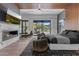 The main bedroom provides a fireplace, tv, outdoor access, neutral decor, and wood slat accents at 4763 N 53Rd St, Phoenix, AZ 85018