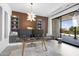 This home office includes custom shelving, decorative lighting, and large sliding doors to the outdoor patio at 4763 N 53Rd St, Phoenix, AZ 85018