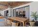 Outdoor dining area featuring a large wooden table, seating for eight, and an open concept living space at 4763 N 53Rd St, Phoenix, AZ 85018
