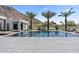 Stunning pool reflects the modern home and mountain backdrop, framed by swaying palm trees and plush lounge furniture at 4763 N 53Rd St, Phoenix, AZ 85018