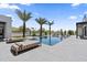 Luxury pool with lounge chairs, surrounded by palm trees, with a sports court in the background under a bright blue sky at 4763 N 53Rd St, Phoenix, AZ 85018