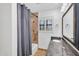 Bathroom featuring a tiled shower, vanity with granite countertop, and shuttered window at 5307 N 32Nd Pl, Phoenix, AZ 85018