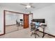 Bedroom with a large desk setup, mirrored closet, and neutral carpeting at 5307 N 32Nd Pl, Phoenix, AZ 85018