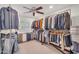 Walk-in closet with ample hanging space, ceiling fan, and organized storage solutions at 5307 N 32Nd Pl, Phoenix, AZ 85018