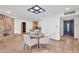 Open-concept dining area with stone floors, stone fireplace, and a seamless transition to the kitchen at 5307 N 32Nd Pl, Phoenix, AZ 85018