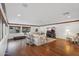 Spacious living room featuring hardwood floors, neutral furniture, and exercise equipment at 5307 N 32Nd Pl, Phoenix, AZ 85018