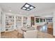 Bright living room with skylight, stone floors, built-in bookshelves, and open layout to a sun-filled room at 5307 N 32Nd Pl, Phoenix, AZ 85018