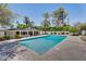 A beautifully landscaped backyard featuring a sparkling swimming pool with stone surround at 5307 N 32Nd Pl, Phoenix, AZ 85018