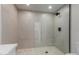Modern bathroom features neutral tile and a frameless glass shower enclosure at 5909 E Crocus Dr, Scottsdale, AZ 85254