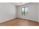 Bright bedroom with hardwood floors and a large window overlooking the yard at 5909 E Crocus Dr, Scottsdale, AZ 85254