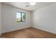 Bedroom with wooden floor and bright natural light from the window at 5909 E Crocus Dr, Scottsdale, AZ 85254